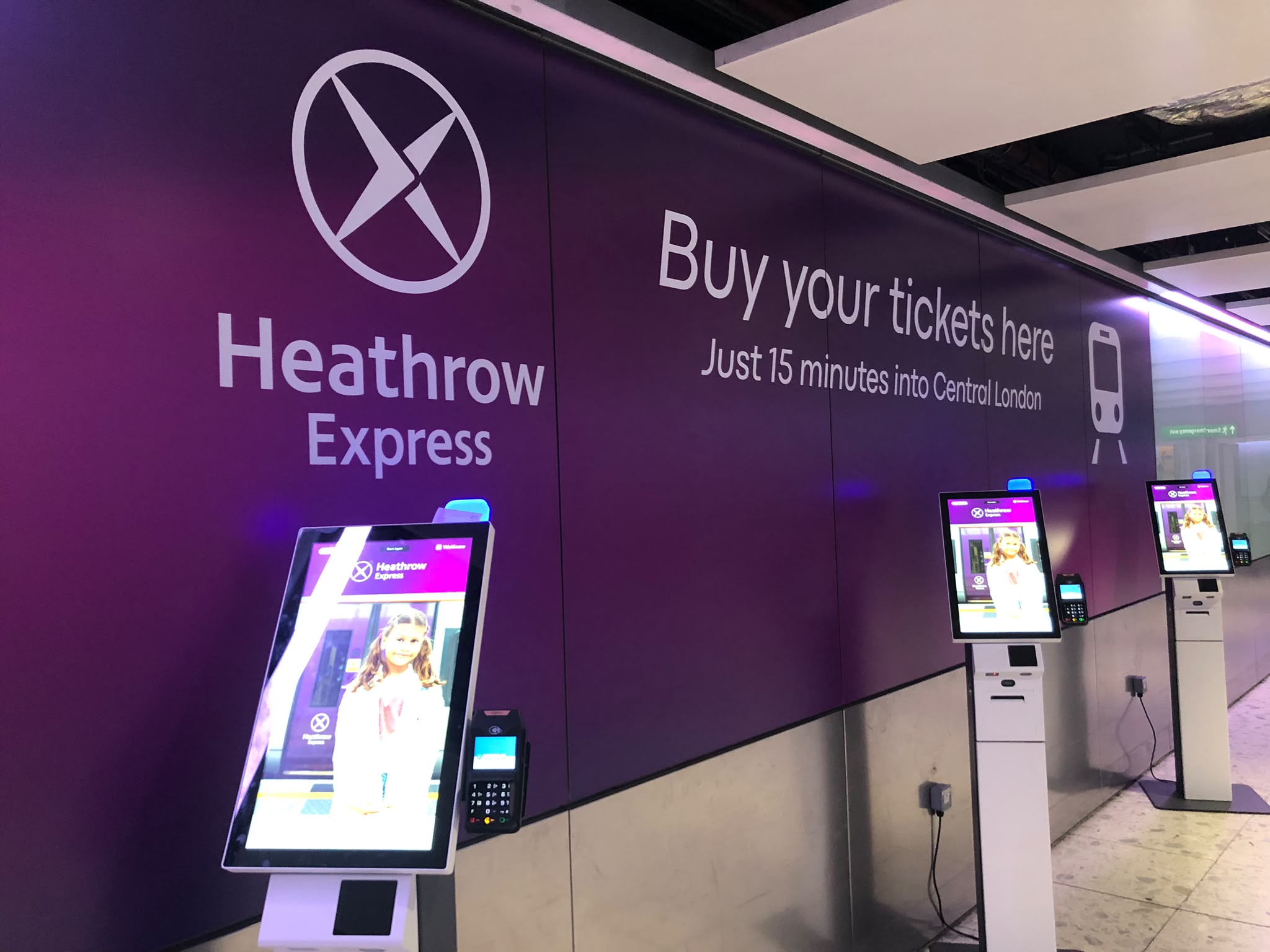 Heathrow Express ticket machine and signage at Heathrow Airport